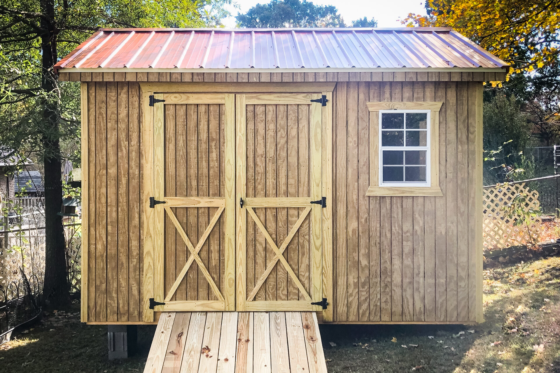 a wooden utility shed with a red roof and a ramp in horse cave ky